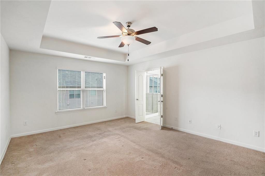 7736 Rutgers Circle Fairburn, GA 30213 - Photo 13 of 39 an empty room with window and ceiling fan