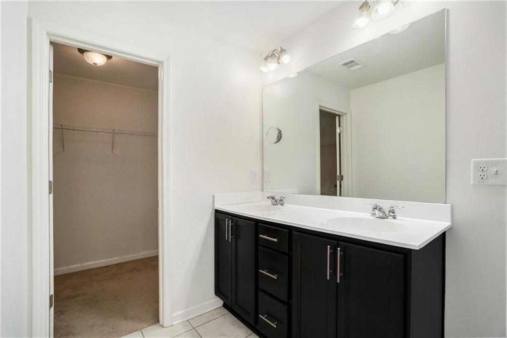 7736 Rutgers Circle Fairburn, GA 30213 - Photo 14 of 39 a bathroom with a sink and a mirror