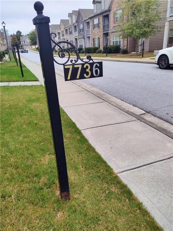 7736 Rutgers Circle Fairburn, GA 30213 - Photo 2 of 39 a view of a street with chairs and a bench in the middle of a yard