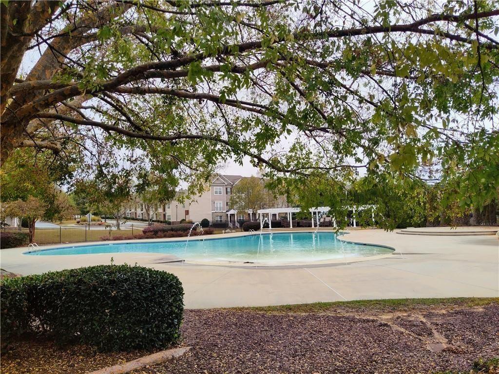 7736 Rutgers Circle Fairburn, GA 30213 - Photo 38 of 39 a view of a swimming pool with a yard and plants