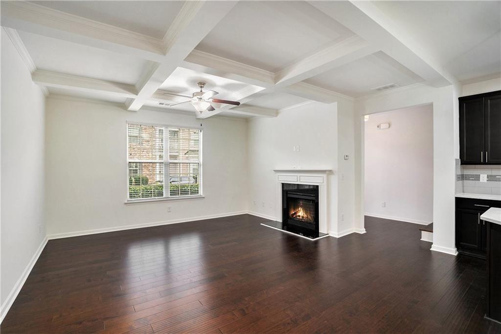 7736 Rutgers Circle Fairburn, GA 30213 - Photo 9 of 39 an empty room with wooden floor fireplace and windows