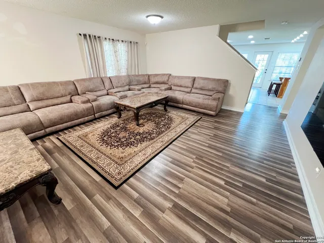 a living room with furniture and a rug