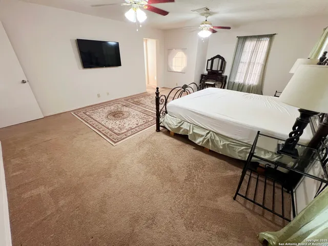 a living room with a flat screen tv and a couch