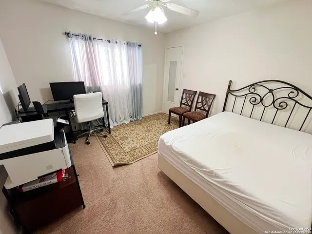 a bedroom with a bed and a tv