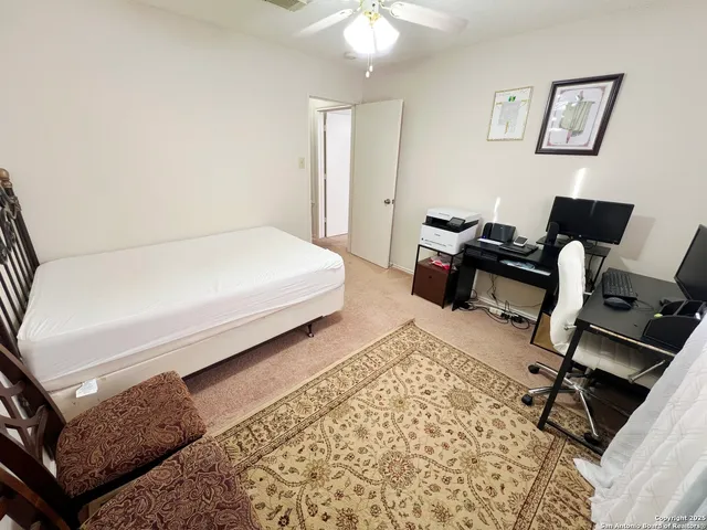 a bed room with a bed window and a chair