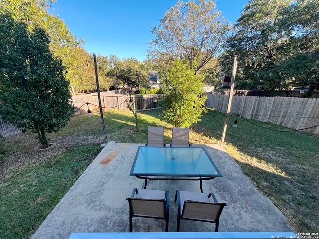 a view of a backyard with sitting area