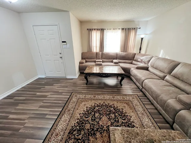 a living room with a couch and a rug