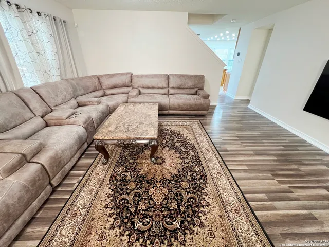 a living room with furniture and a rug