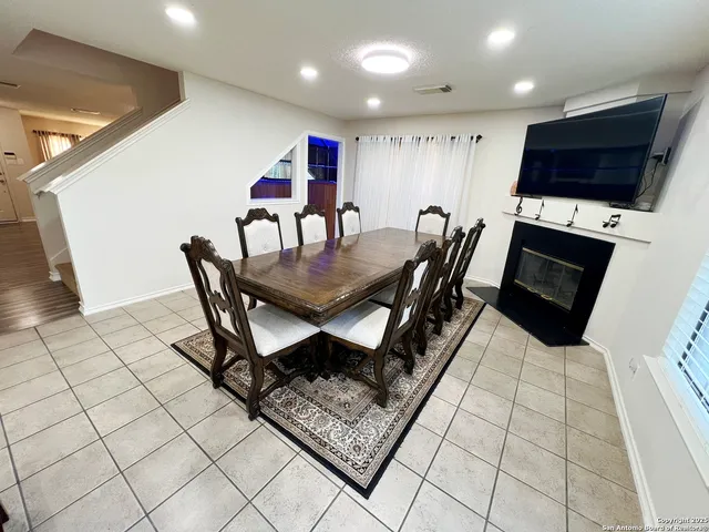 a dining room with furniture and a flat screen tv