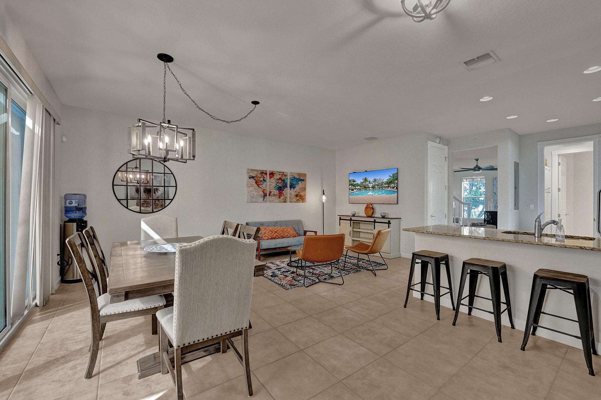 1172 Islamorada Drive Jupiter, FL 33458 - Photo 13 of 42 a view of a dining room with furniture a chandelier and wooden floor