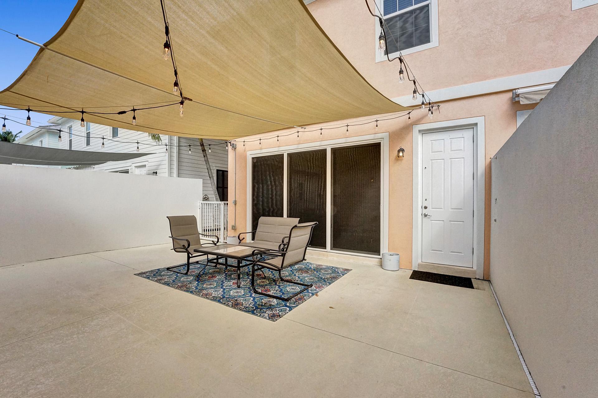 1172 Islamorada Drive Jupiter, FL 33458 - Photo 23 of 42 a view of a patio with table and chairs and potted plants