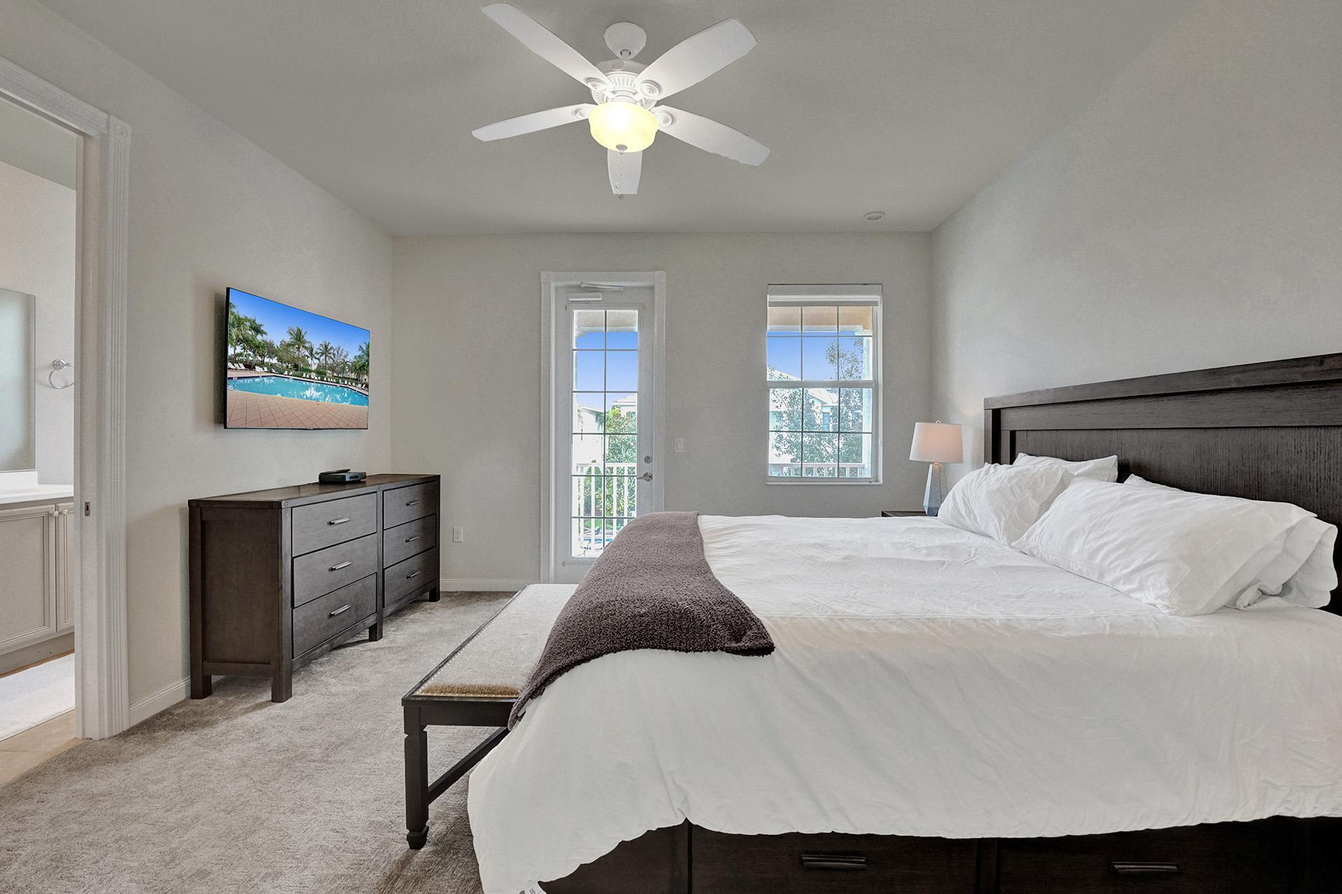 1172 Islamorada Drive Jupiter, FL 33458 - Photo 27 of 42 a bedroom with a large bed and a window