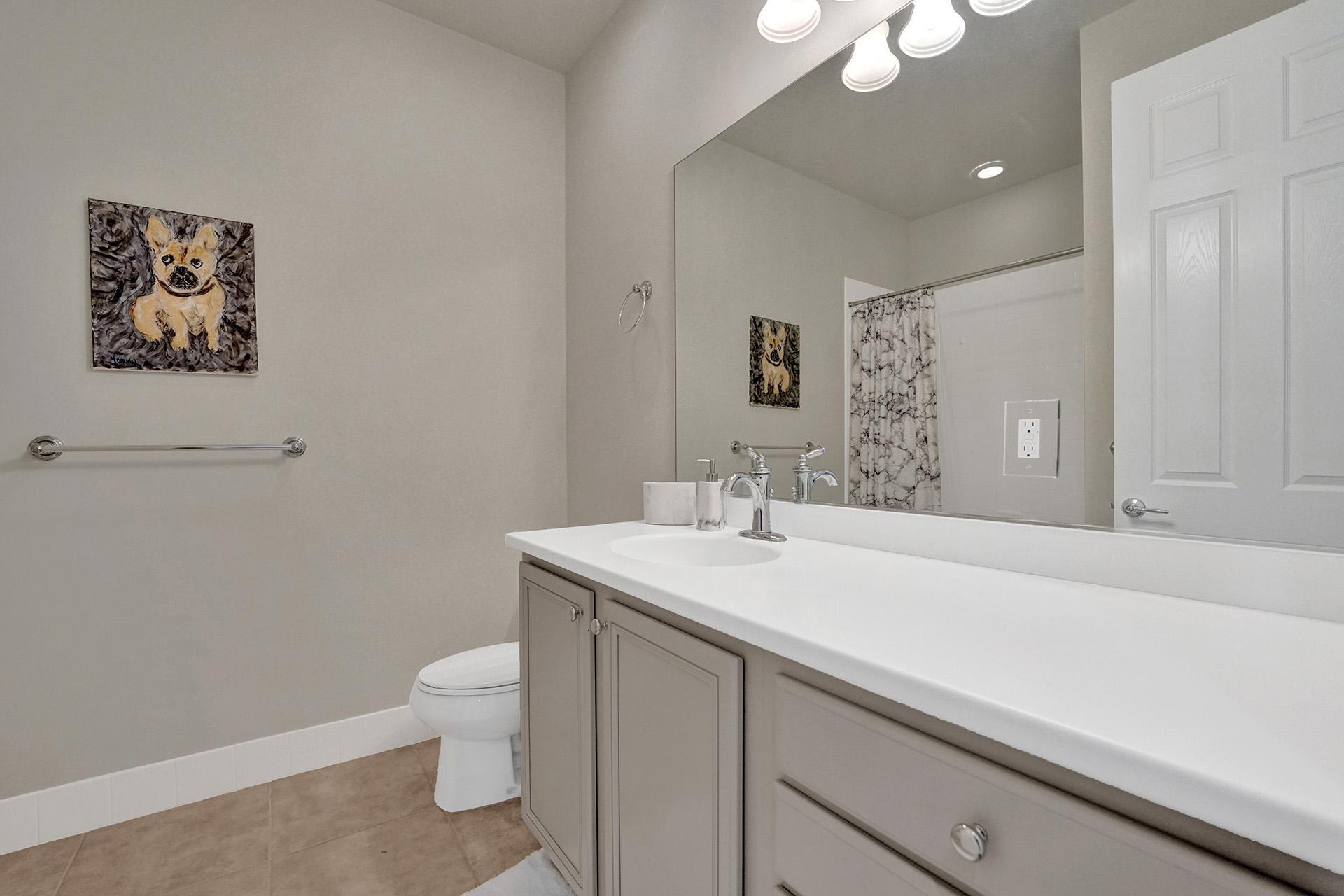 1172 Islamorada Drive Jupiter, FL 33458 - Photo 35 of 42 a bathroom with a toilet a sink and mirror