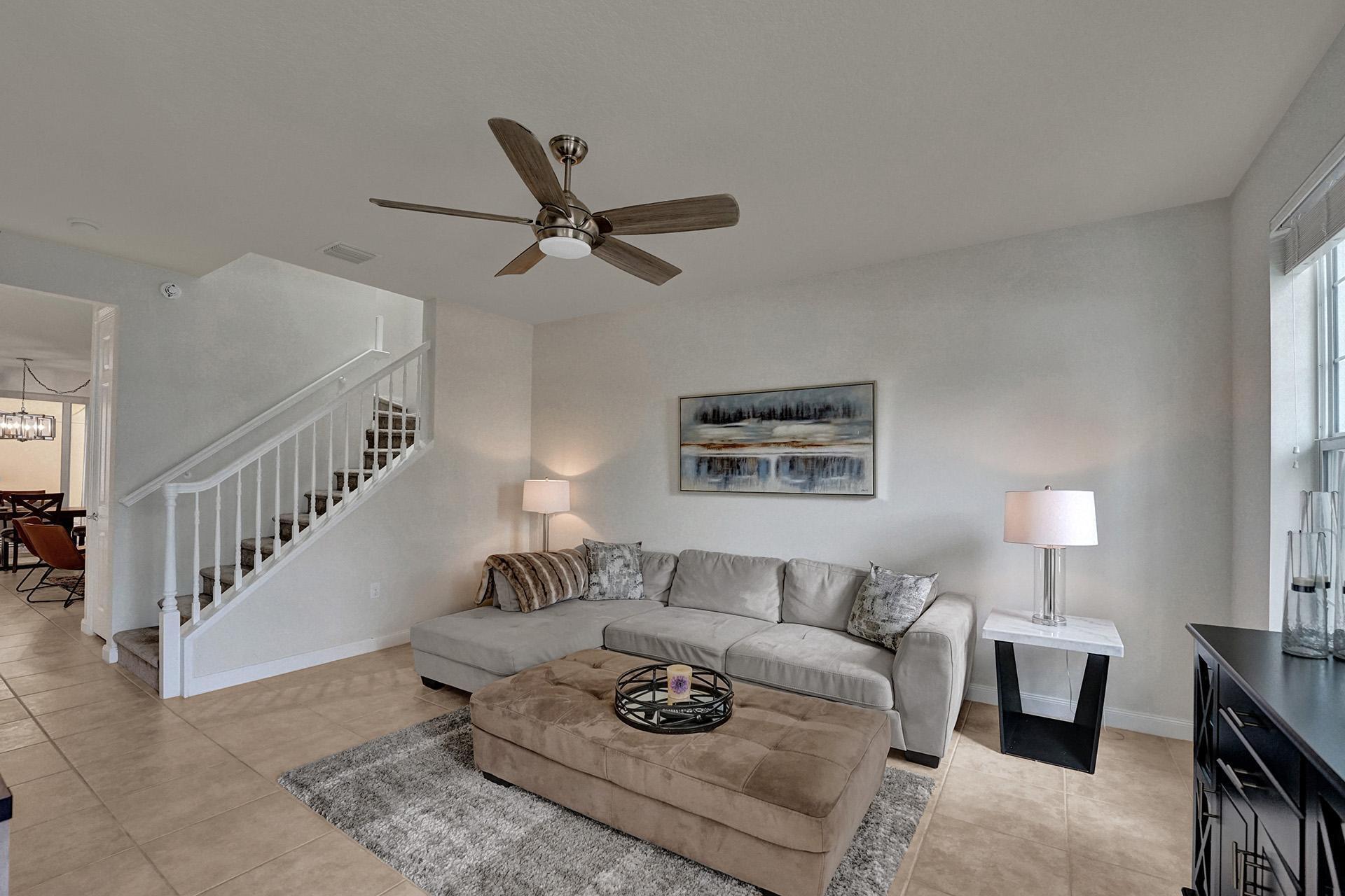 1172 Islamorada Drive Jupiter, FL 33458 - Photo 5 of 42 a living room with furniture and a ceiling fan