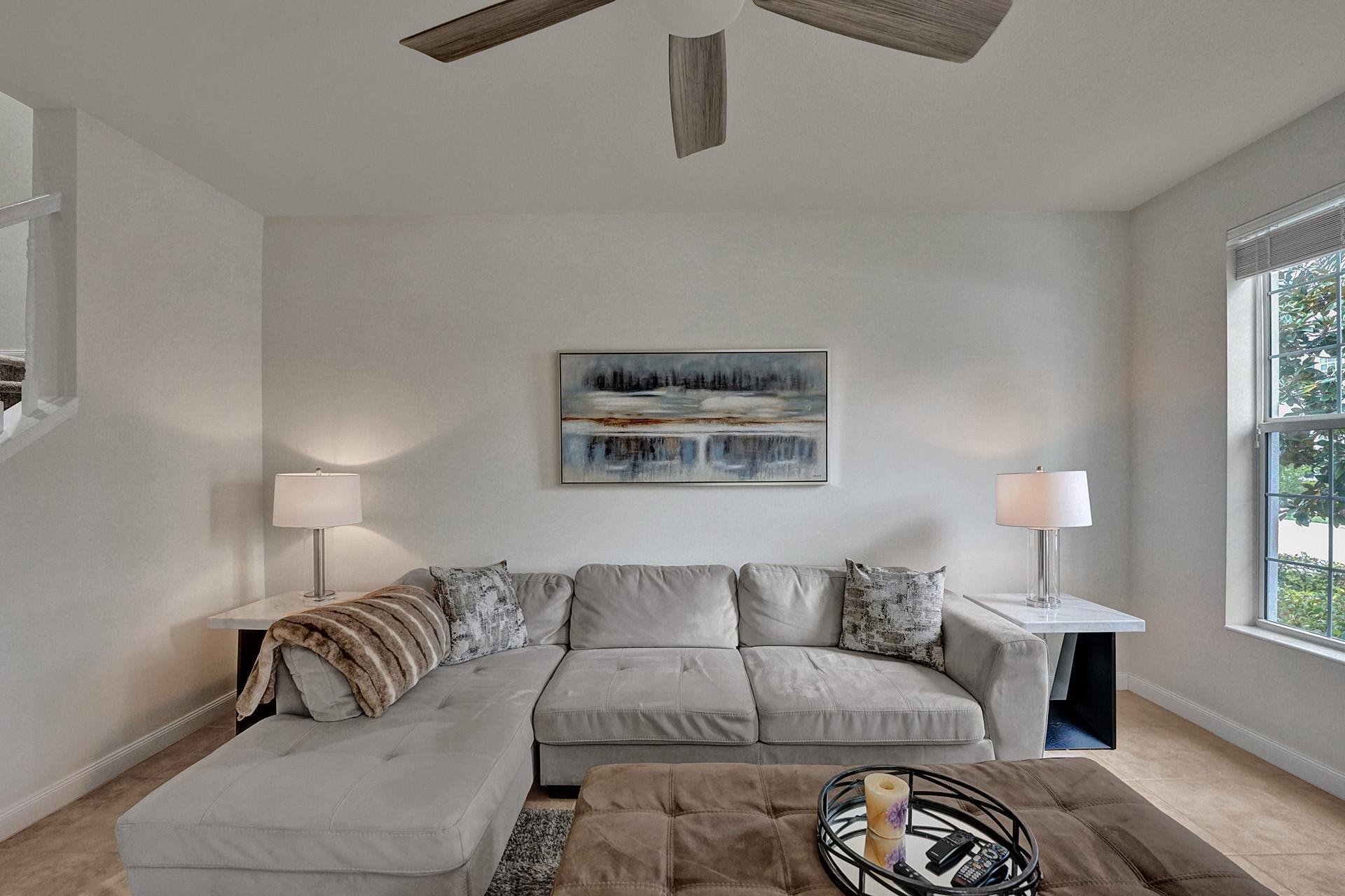 1172 Islamorada Drive Jupiter, FL 33458 - Photo 6 of 42 a living room with furniture and a lamp