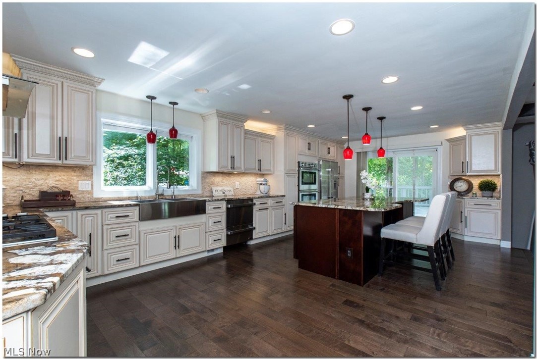 3200 Lander Road Pepper Pike, OH 44124 - Photo 2 of 35 The gourmet kitchen comes equipped with an abundance of cabinet space, center island, and high-end stainless steel appliances including a counter top range and double ovens.
Sliders allow access to a sizable back deck