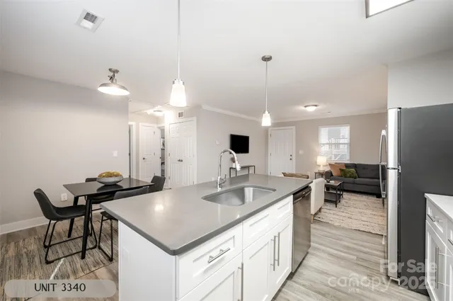 a kitchen with a kitchen island a sink appliances and a counter top space