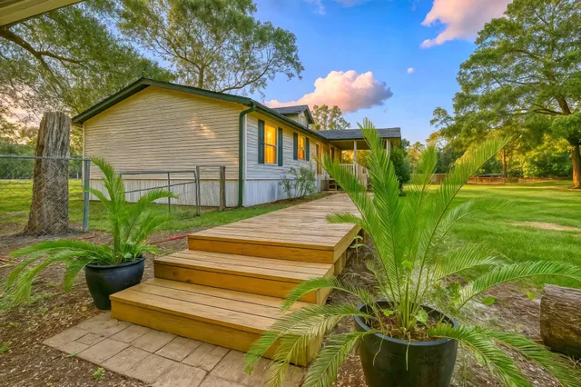 a yellow house with trees in front of it