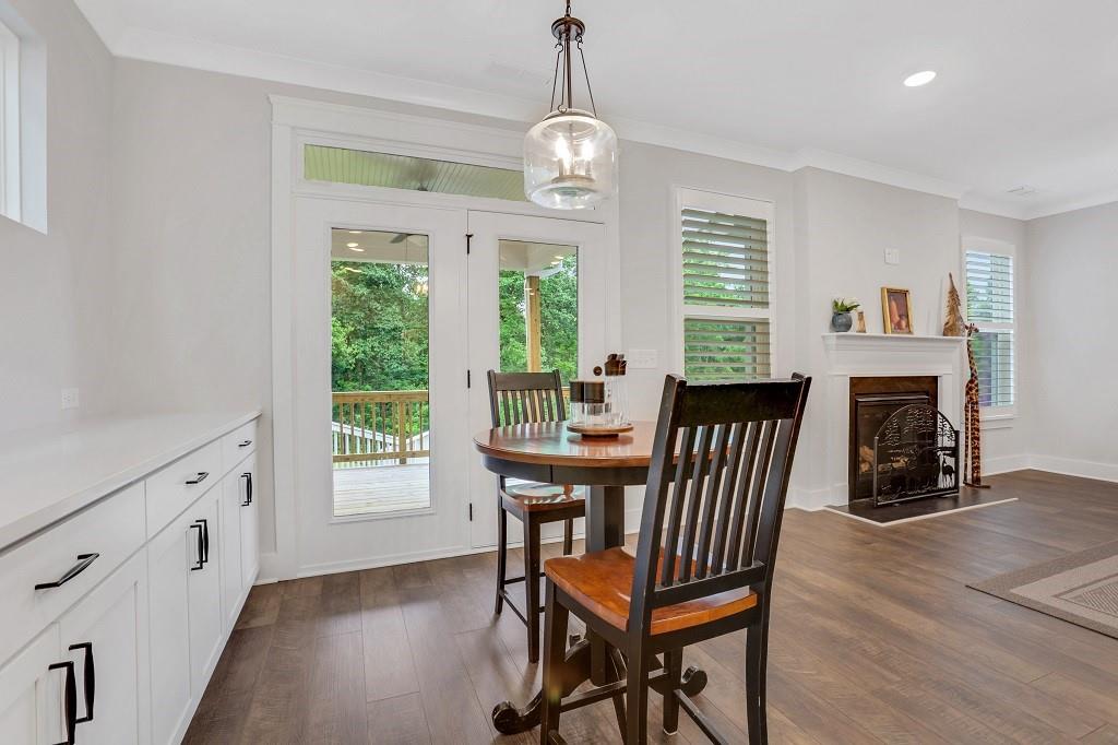 413 Solace Place Canton, GA 30114 - Photo 15 of 75 a view of a dining room with furniture window and wooden floor