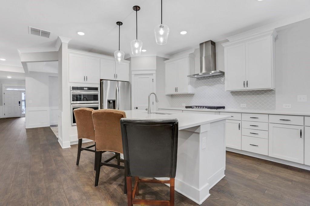 413 Solace Place Canton, GA 30114 - Photo 16 of 75 a kitchen with kitchen island appliances cabinets and furniture