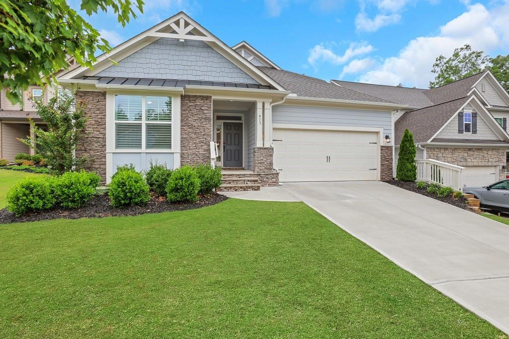 413 Solace Place Canton, GA 30114 - Photo 2 of 75 a front view of a house with a yard