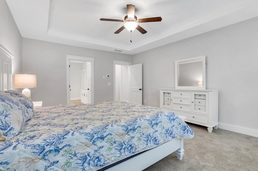 413 Solace Place Canton, GA 30114 - Photo 25 of 75 a bedroom with a bed and a chandelier