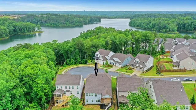 an aerial view of a house with outdoor space and lake view