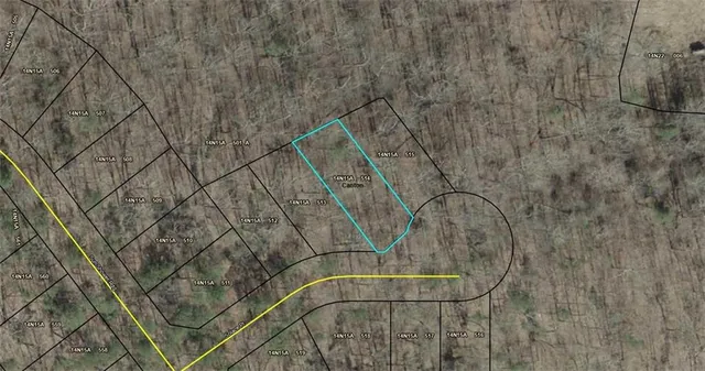 a view of a hallway with wooden floor and a bathroom