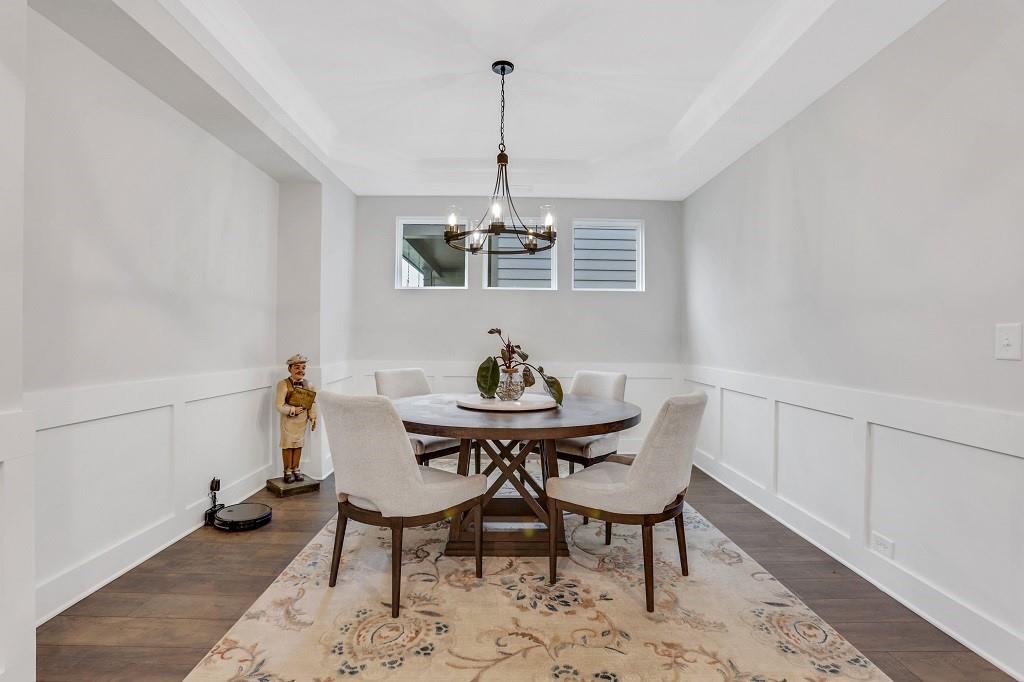 413 Solace Place Canton, GA 30114 - Photo 59 of 75 a view of a dining room with furniture window and wooden floor