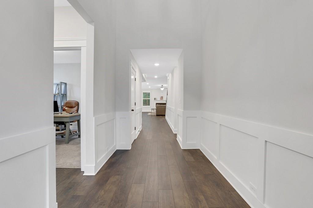 413 Solace Place Canton, GA 30114 - Photo 71 of 75 a view of a hallway with wooden floor and a bathroom