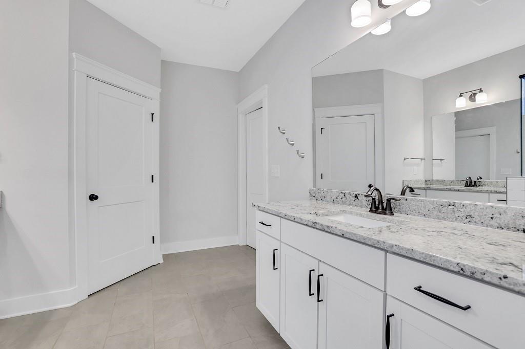 413 Solace Place Canton, GA 30114 - Photo 73 of 75 a bathroom with a granite countertop sink and a mirror