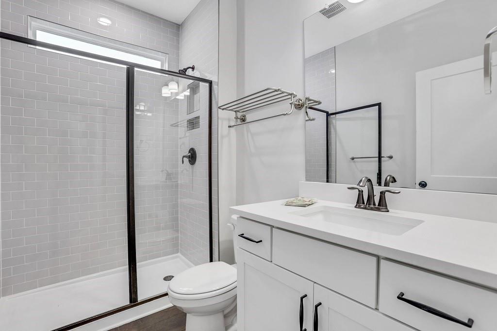 413 Solace Place Canton, GA 30114 - Photo 74 of 75 a bathroom with a sink toilet and shower