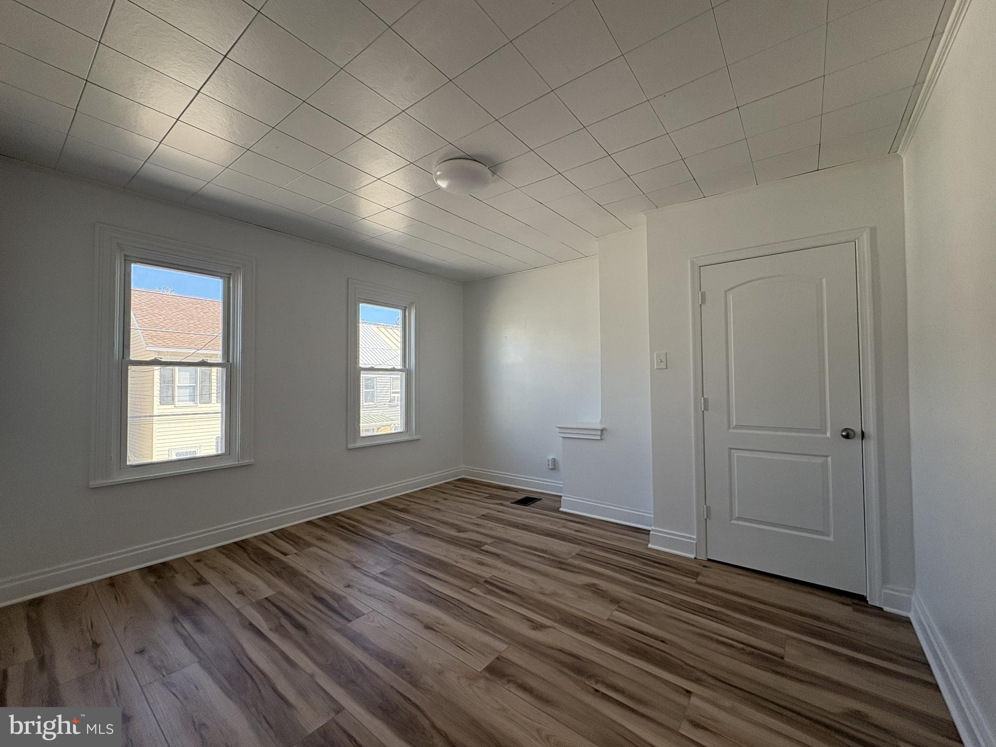 156 East Penn Street Carlisle, PA 17013 - Photo 15 of 17 a view of an empty room with wooden floor and a window
