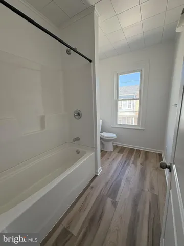 a spacious bathroom with a bathtub and a shower