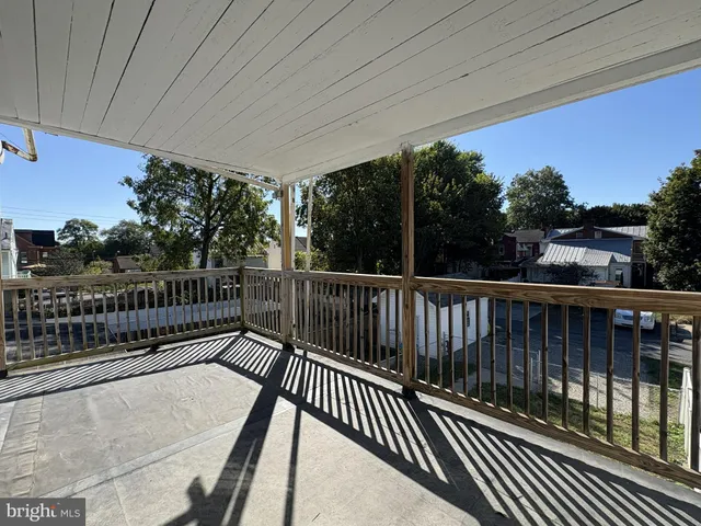 a balcony with view of trees in the background