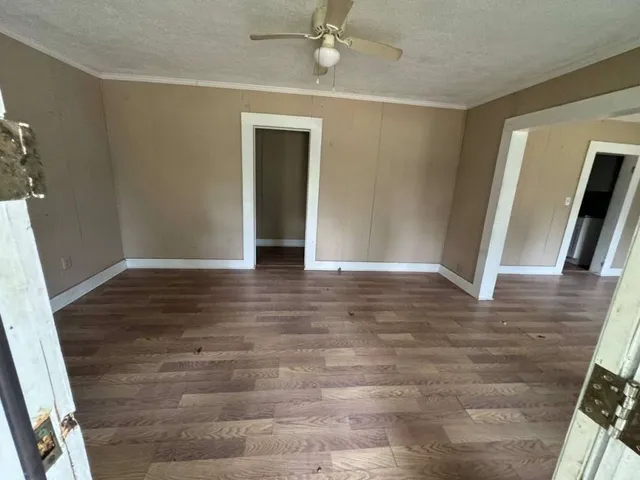 wooden floor in an empty room with a window