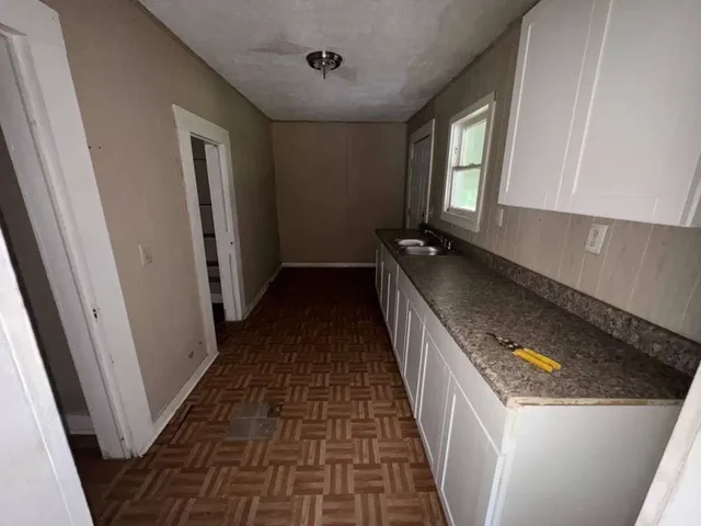 a kitchen with granite countertop a stove and a refrigerator
