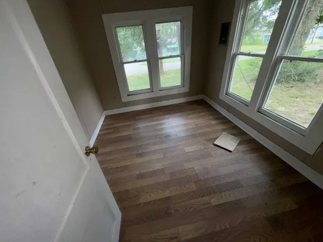 a view of entryway and hall with wooden floor