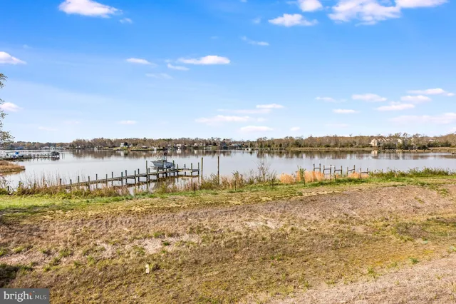 a view of a lake with houses in the back