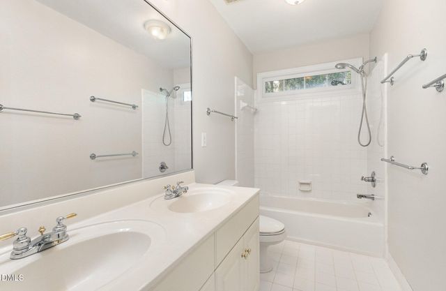 an empty room with windows and ceiling fan