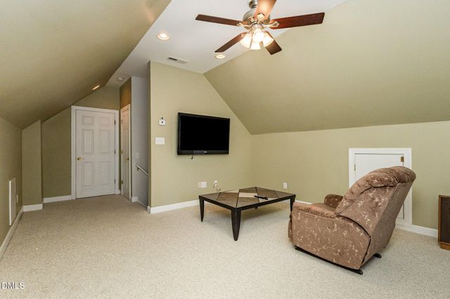 a view of a patio with couple of chairs and a fire pit