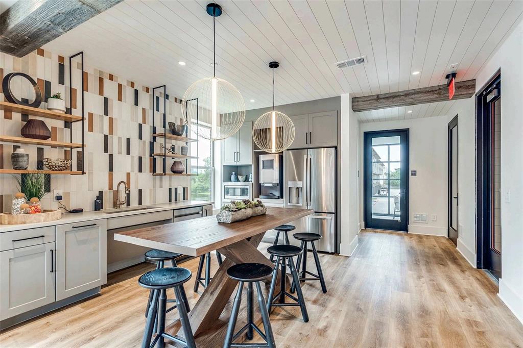 4020 McEwen Road, Unit 9123 Farmers Branch, TX 75244 - Photo 17 of 20 Kitchen with gray cabinetry, wooden ceiling, appliances with stainless steel finishes, open shelves, and light wood finished floors