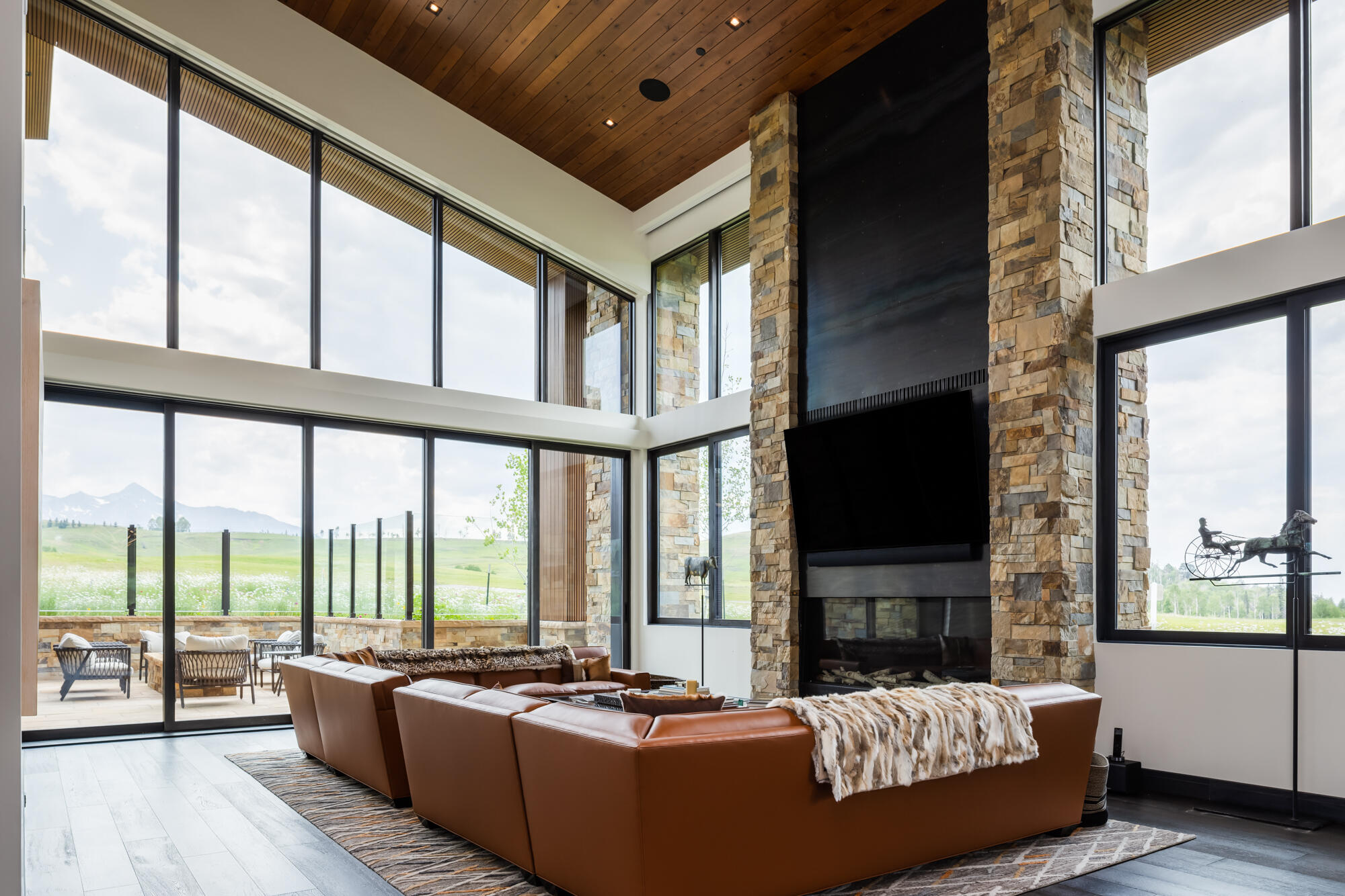 167 Adams Ranch Road Mountain Village, CO 81435 - Photo 10 of 28 a living room with furniture fireplace and flat screen tv