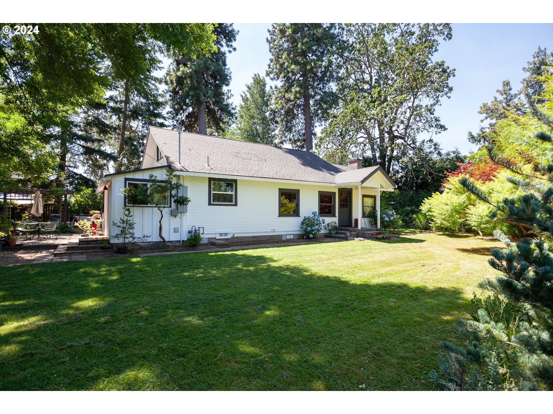 1891 Tucker Road Hood River, OR 97031 - Photo 3 of 36 a front view of a house with a garden