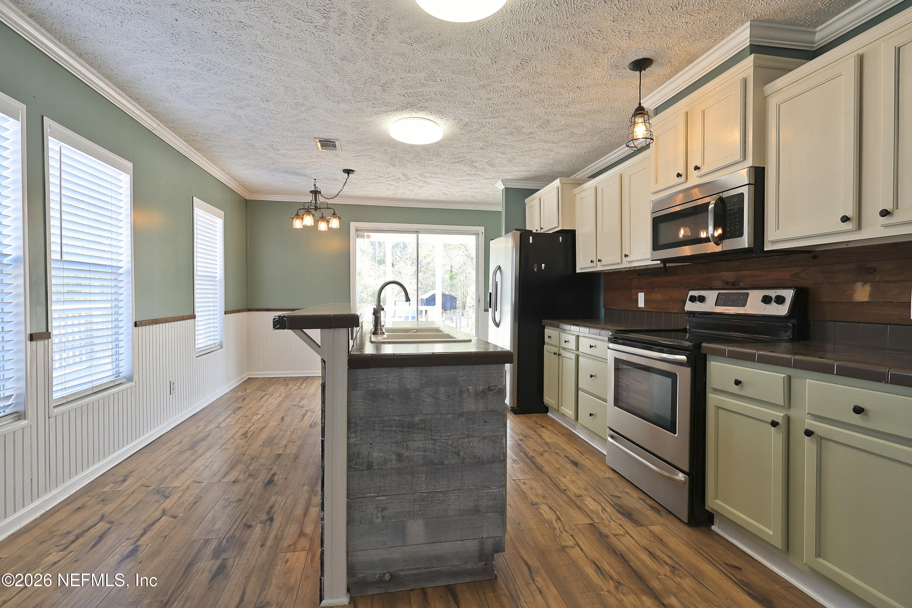 4680 Southeast 92nd Street Starke, FL 32091 - Photo 13 of 80 a kitchen with stainless steel appliances granite countertop a stove a sink and a microwave
