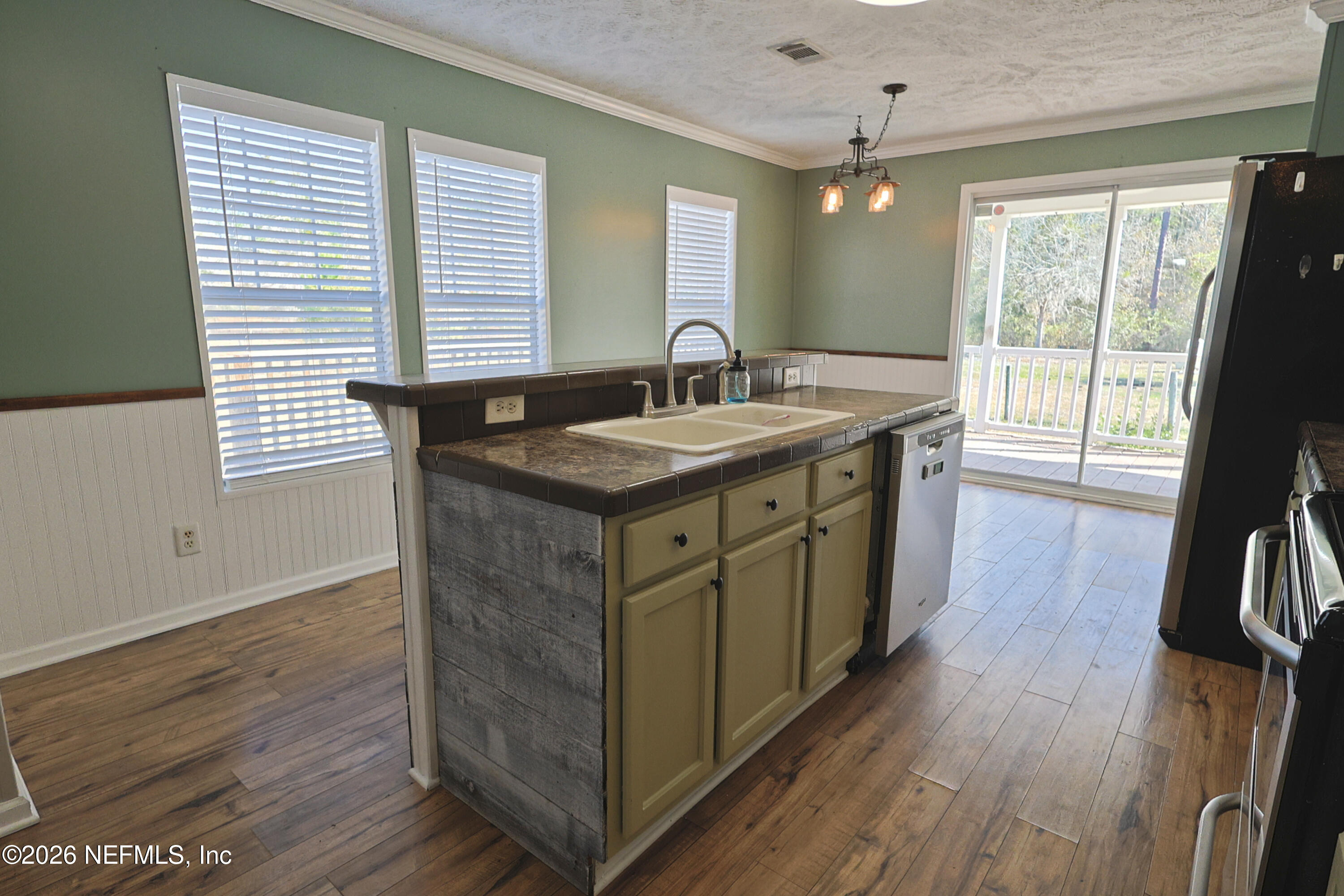 4680 Southeast 92nd Street Starke, FL 32091 - Photo 15 of 80 a kitchen with a sink and wooden floor