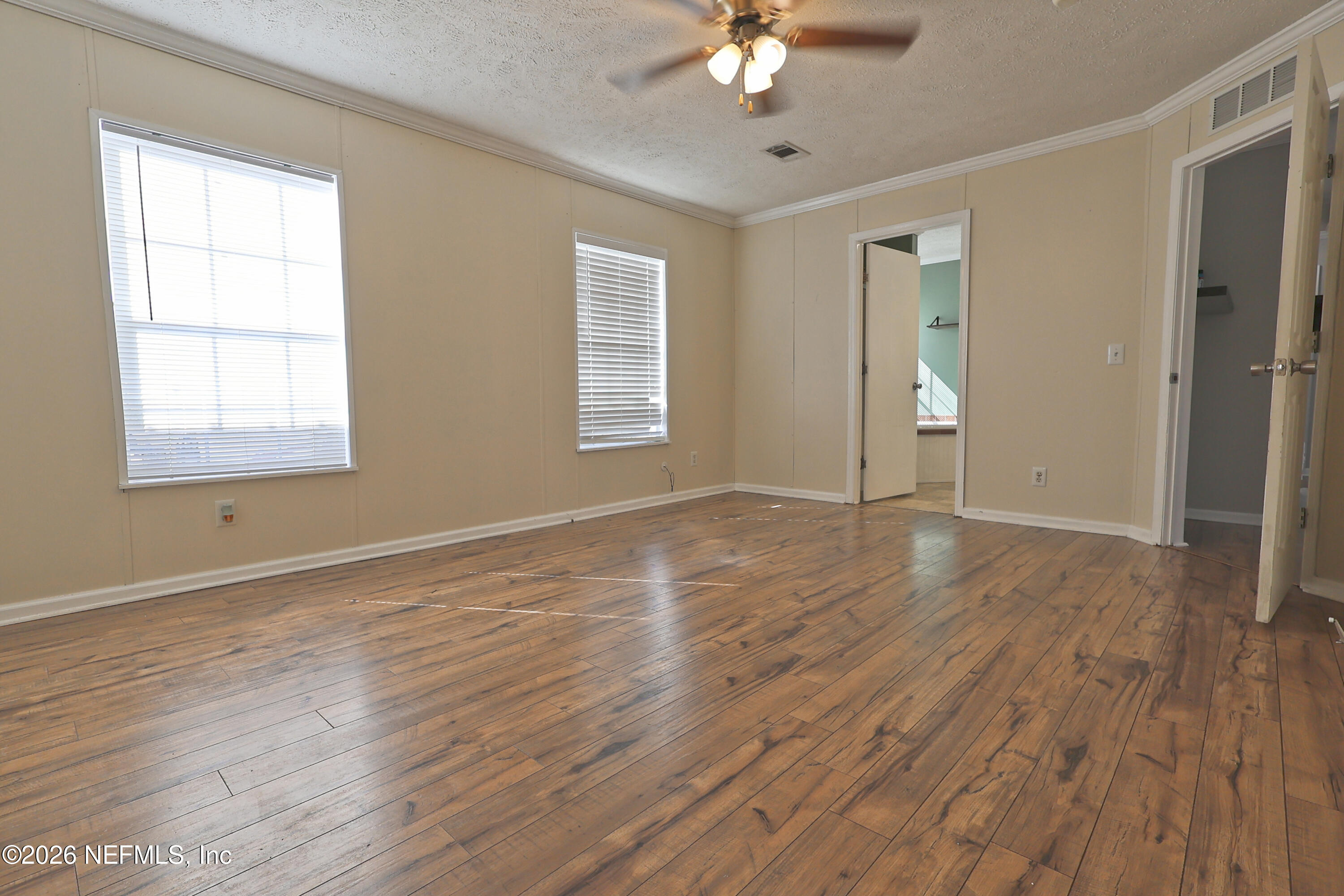 4680 Southeast 92nd Street Starke, FL 32091 - Photo 25 of 80 a view of an empty room with wooden floor and a window