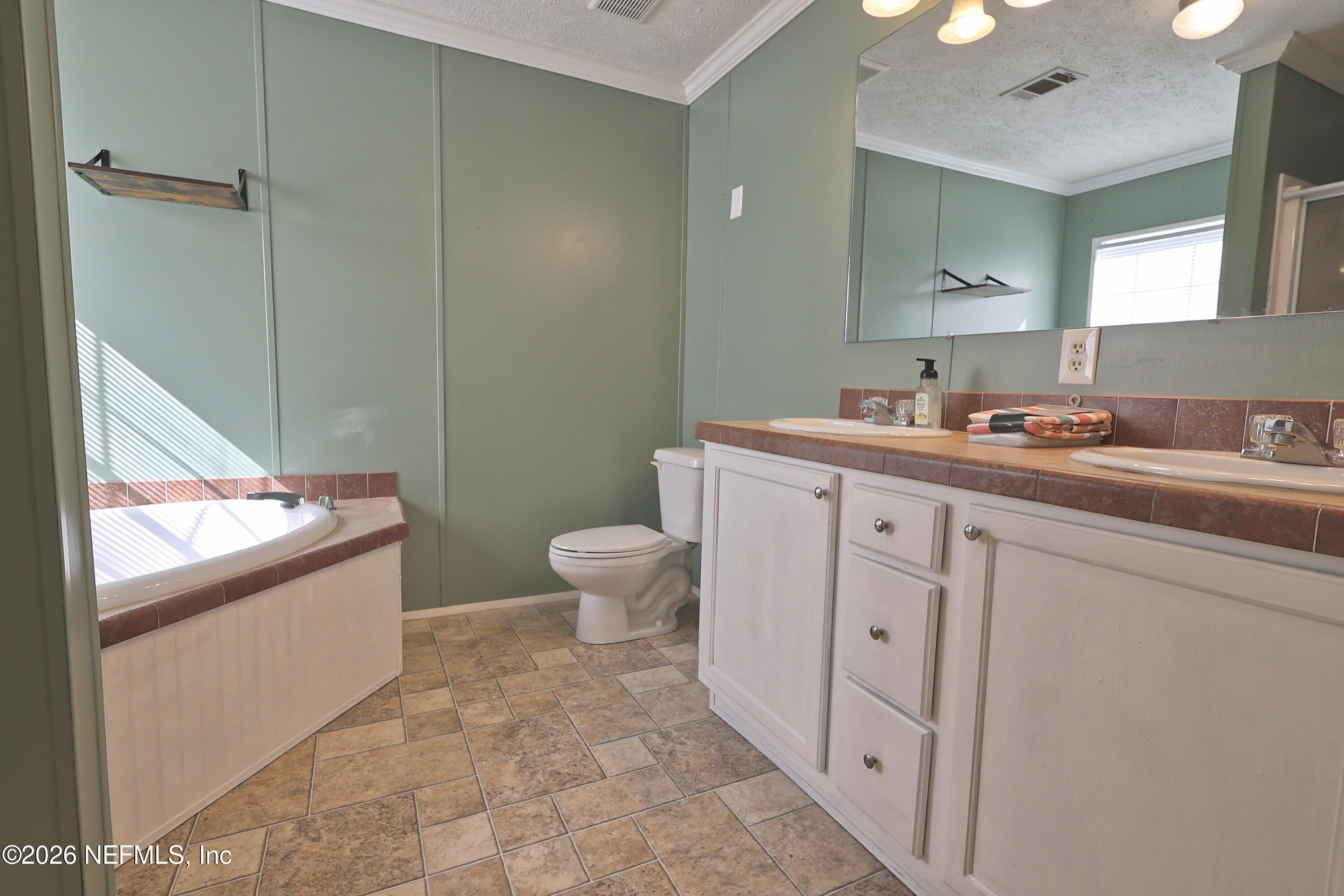 4680 Southeast 92nd Street Starke, FL 32091 - Photo 26 of 80 a spacious bathroom with a toilet sink and mirror