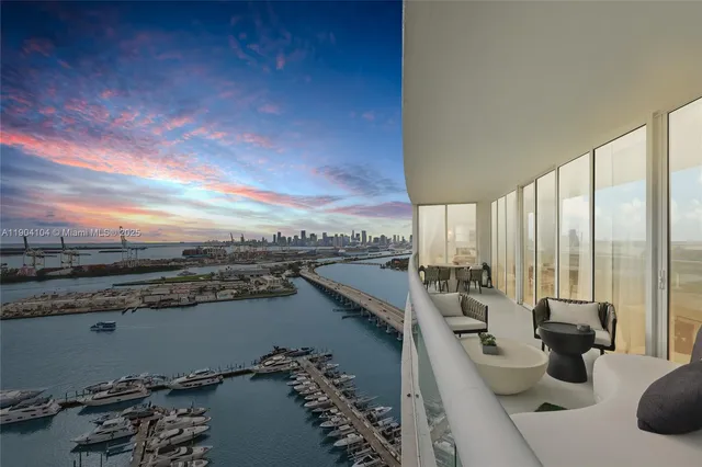 a view of a balcony with two chairs and a table