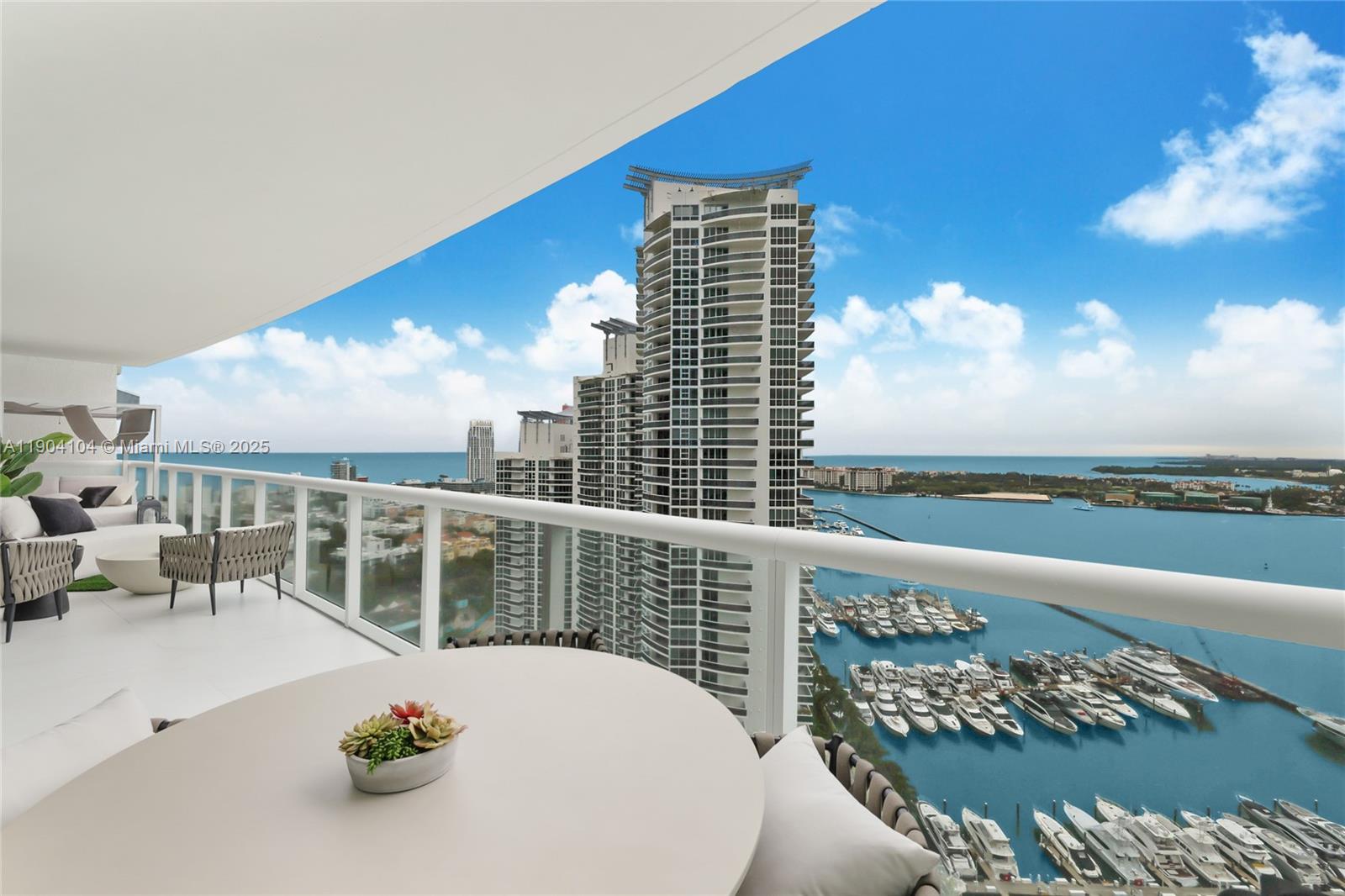 450 Alton Road, Unit 2603 Miami Beach, FL 33139 - Photo 17 of 64 a view of a balcony with two chairs and a table